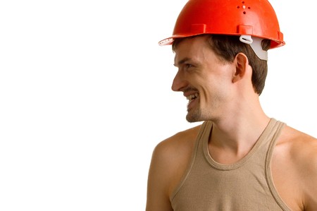 young smiling worker in a red building helmet. Isolation on white backgroundの写真素材