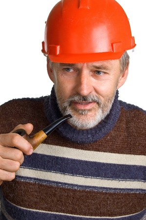 Elderly men in a red building helmet with a pipe in a hand. Isolation on a white background