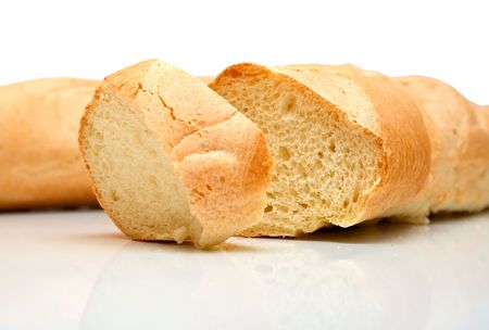 Fresh tasty bread which is cut on a part. Isolation on white. Shallow DOF.