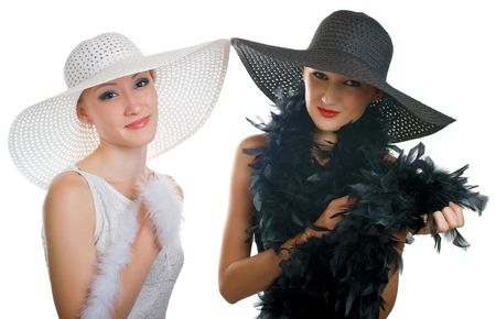 Two beautiful girls in hat and boa. Isolation on white backgroundの写真素材