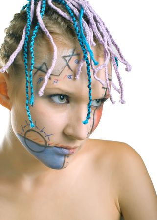 Portrait of beautiful young girl with plaits and geometrical makeup on white background. Shallow DOF, focus on left eyeの写真素材