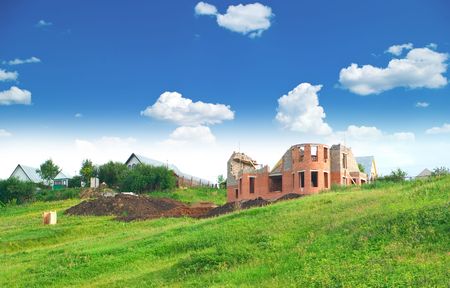 Not complete building of the private house against summer landscape with cloudy skyの写真素材