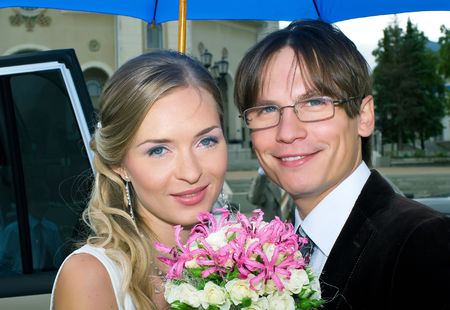 Smiling bride and groom against urban landscapeの写真素材