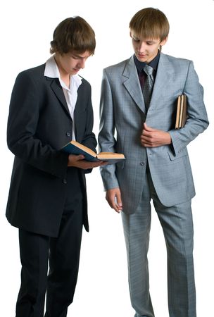 Two young happy students reading the books. Isolation on white backgroundの写真素材