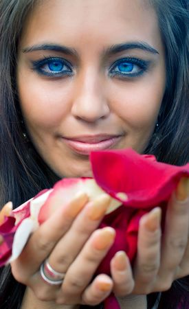 Portrait of young women with petals in hand. Shallow DOFの写真素材