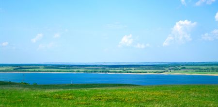 Summer landscape with blue lake and cloudy sky
の写真素材