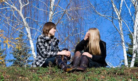 Two girlfriends against autumn natureの写真素材