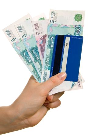 Credit card and denominations in a female hand. Isolation on a white backgroundの写真素材