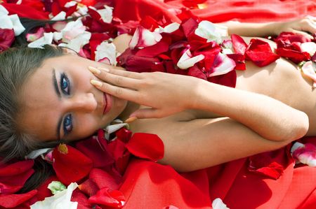 Beautiful young girl in rose petal. Spa resortの写真素材