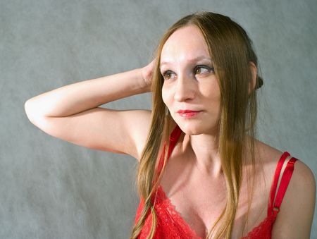 Portrait of young women in red on grey background
の写真素材