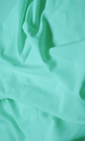 Abstract background, azure silk fabric with waves. Shallow DOFの写真素材