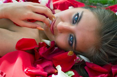 Beautiful young girl in rose petal. Spa resortの写真素材
