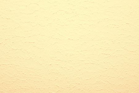 Texture of the wall painted yellow color. A backgroundの写真素材