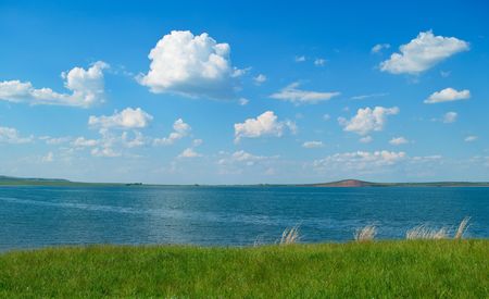 Summer landscape with quiet water of lake and hillの写真素材