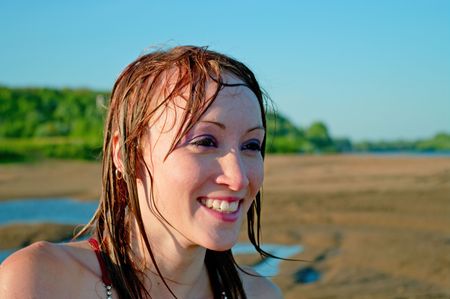 Beautiful young girl against summer landscapeの写真素材