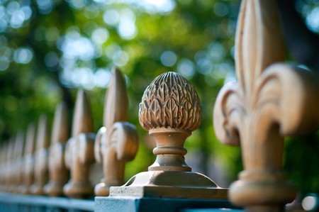Part of an old iron fencing against the summer treesの写真素材