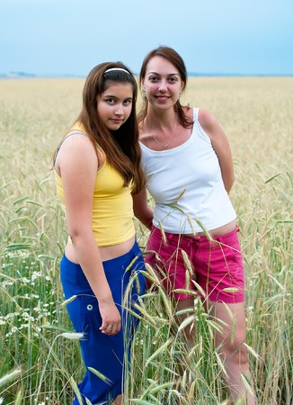 Two smiling beautiful girls in rye field. Shallow DOF の写真素材