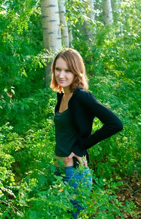 Beautiful girl in black against summer landscapeの写真素材