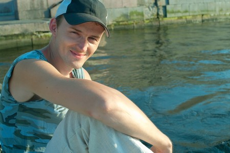 Portrait of the young men against the river. Shallow DOF の写真素材
