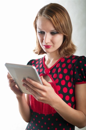 beautiful girl and computer on light background. Shallow DOF の写真素材