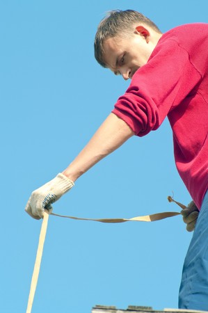 The young worker against the blue skyの写真素材