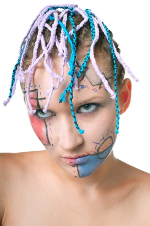 Portrait of beautiful young girl with plaits and geometrical makeup on white background. Shallow DOF の写真素材