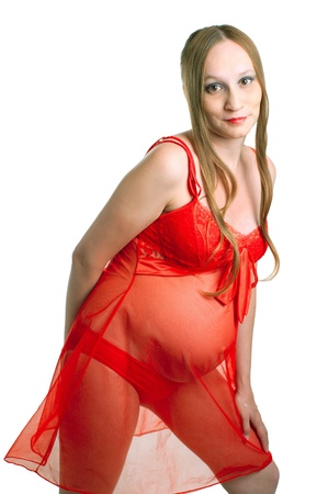 Portrait of young pregnant women in red dress on white background. Isolationの写真素材