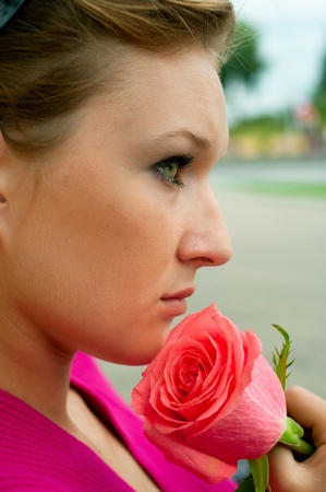 Portrait of the beautiful girl with pink rose. Shallow DOFの写真素材