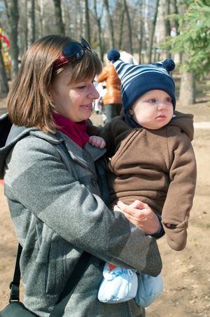 young women with little boy in spring park.の写真素材