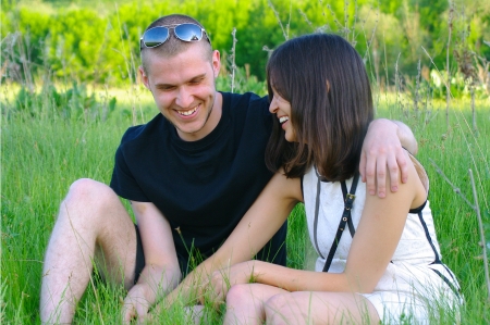 The beautiful girl and the young men against green landscape. Shallow DOFの写真素材