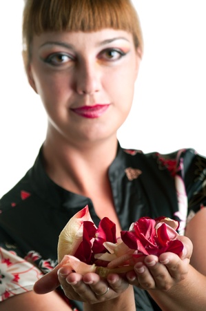 Portrait of young women holding petals of the roses  Shallow DOF, focus on petals の写真素材