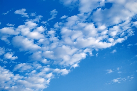 The blue sky background with white cloudsの写真素材