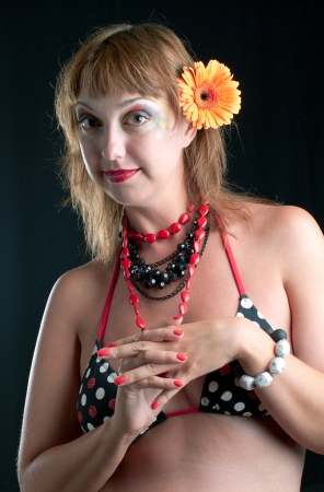 The beautiful adult woman in bathing suit on black backgroundの写真素材