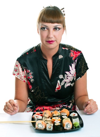Beautiful young woman eating rolls. Shallow DOF, focus ion girl. Isolated on white の写真素材