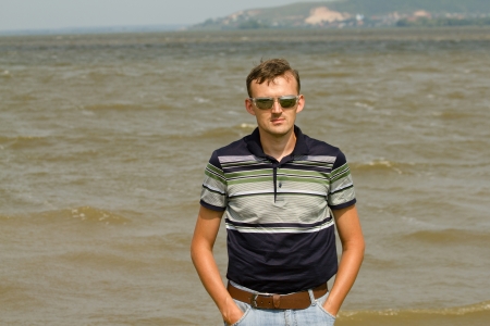 Young men against summer landscape with river Volgaの写真素材