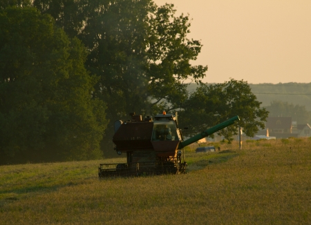 Machine for harvesting in field at evening. Shallow DOFの写真素材