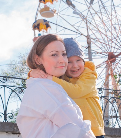 Mother and son on Ferris wheel backgroundの写真素材