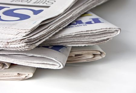Close-up of a stack of newspapers. Shallow DOF with the focus on the closest point to the viewer.