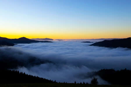 Majestic sunset with fog in the mountains landscape.Carpathian, Ukraine, Beautiful Background