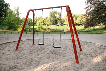 swings hanging from chains in a children's park.