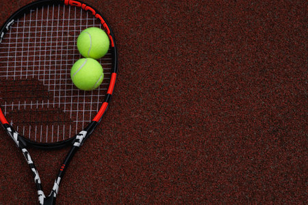 Close up of tennis rackets and tennis balls lying on tennis court. sport, tennis and activity.