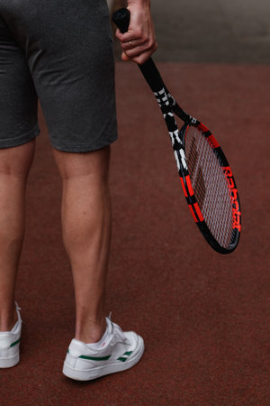 male legs with a tennis racket. Playing tennis on the tennis court. Sport. sports legs