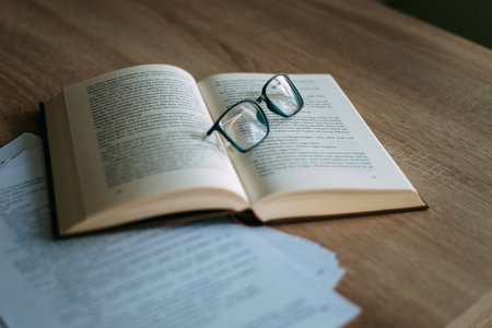 Glasses and books placed on table in the living room .Educational concepts and knowledgeの写真素材