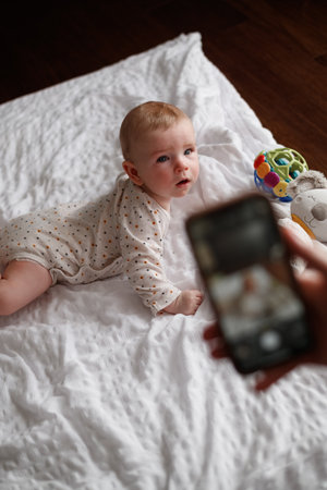 photographing a baby on the phone. Photo camera of a smartphone.