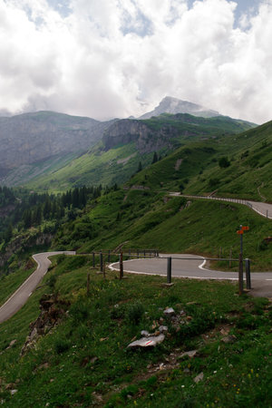 Winding mountain roads through Swiss alpine passes, offering dramatic views and an unforgettable driving experienceの写真素材