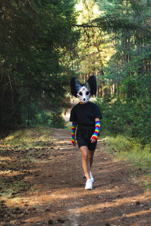 A quadrobing character walks playfully through a leafy forest, moving forward with a light and...