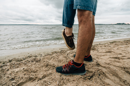 feet on the sand near the waterの写真素材
