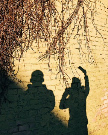 shadows of people on a brick wallの写真素材