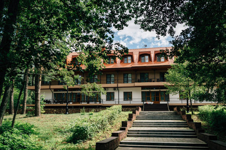 the building in the woods, through the branchesの写真素材