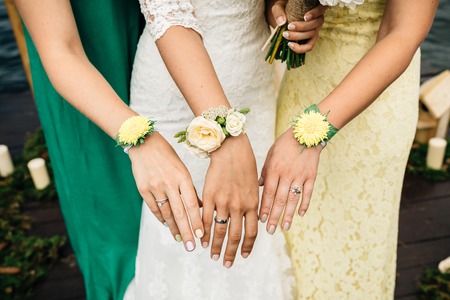 hands of the bride and bridesmaids, chamomileの写真素材
